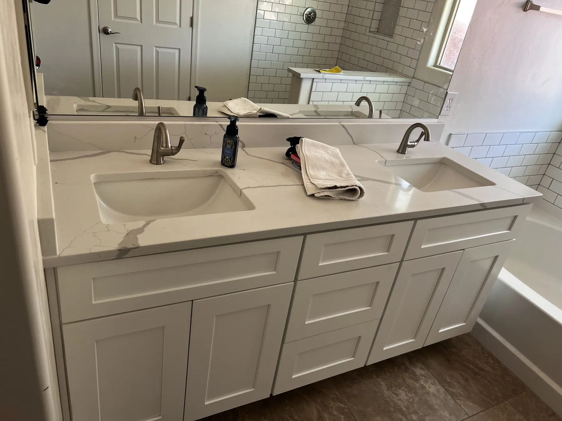 Completed bathroom remodel with coordinated double vanity and mirrors