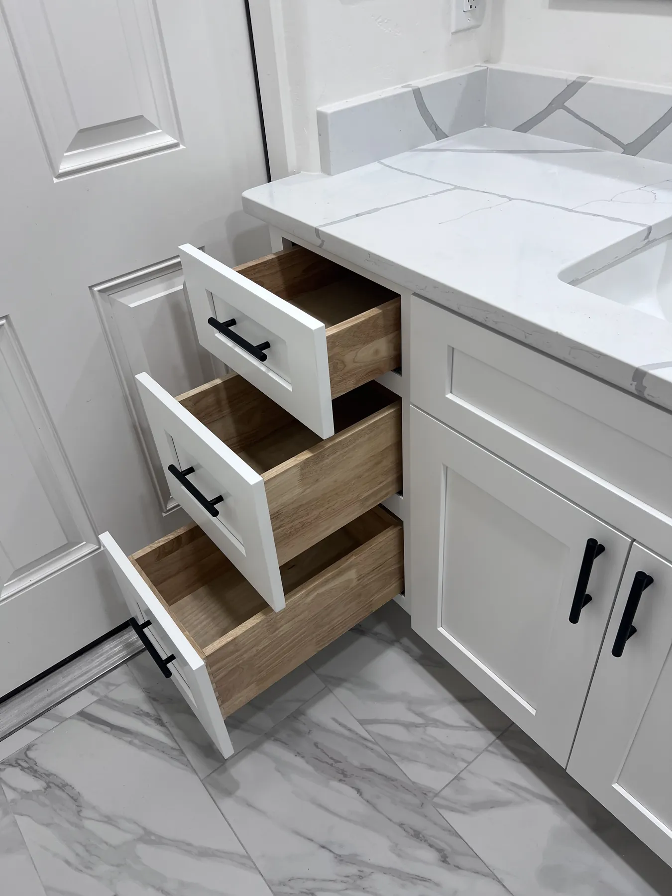 Bathroom vanity with open drawers showing integrated storage