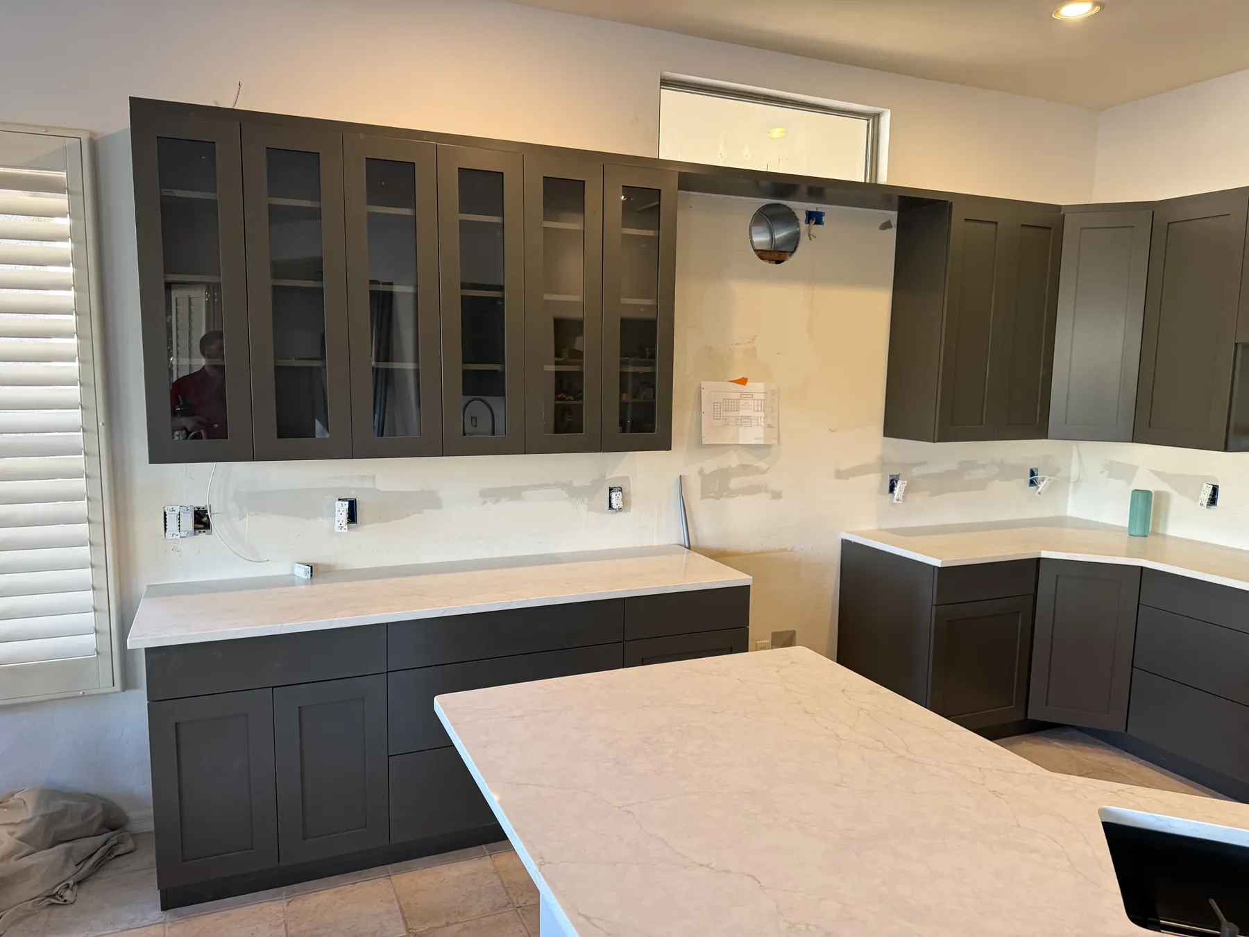 Gray kitchen cabinetry installation in progress