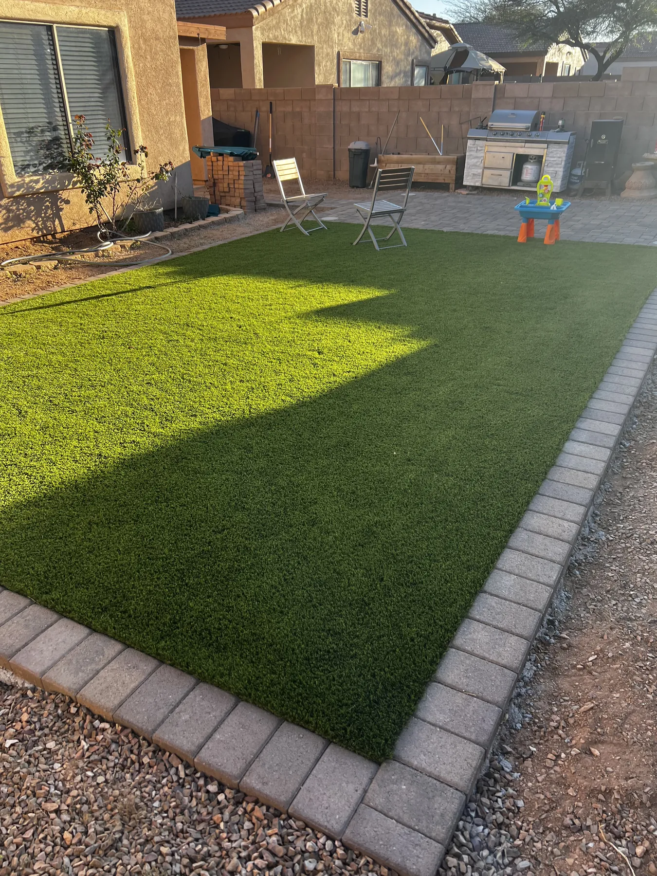 Artificial turf with coordinated paver border