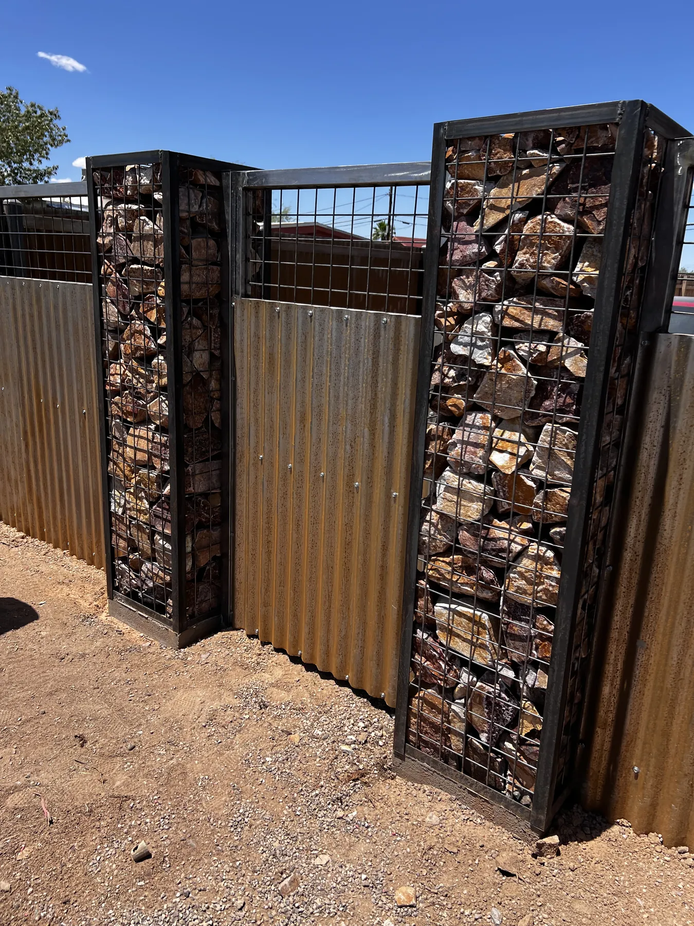 Completed gate framed by stone columns