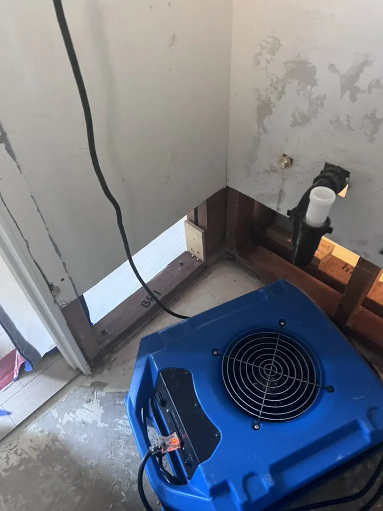 Air mover directed toward an opened wall and plumbing cavity