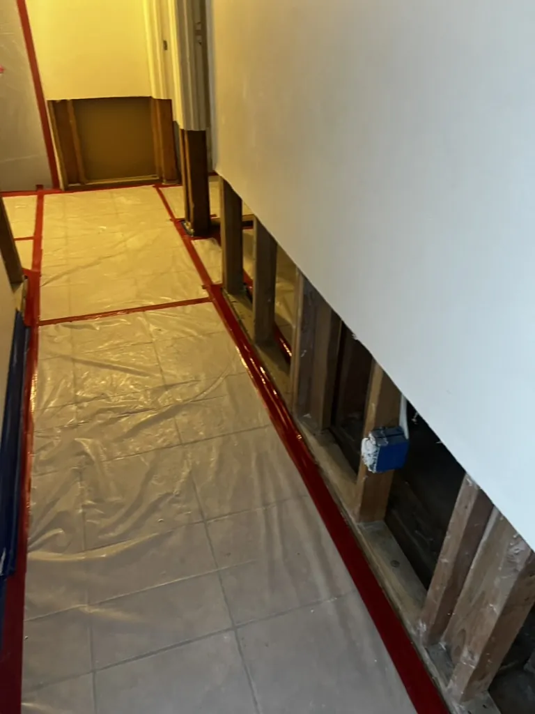 Protected corridor floor beside controlled lower-wall openings