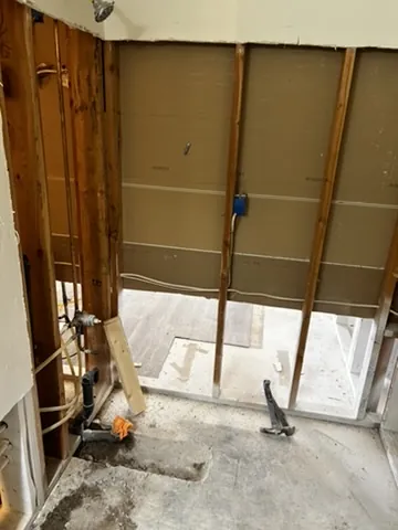 Floor-to-ceiling wall cavity exposed during controlled material removal