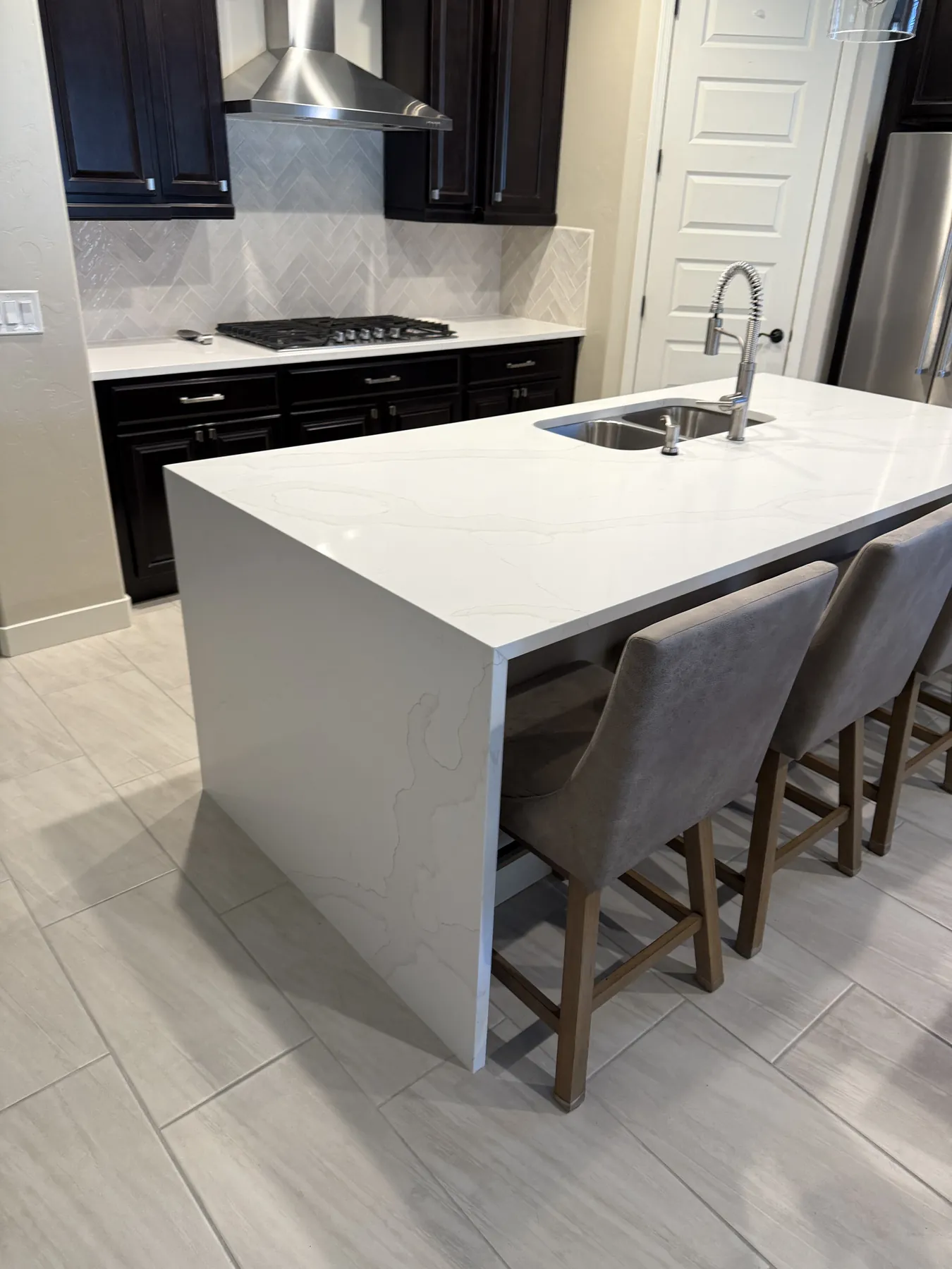 Finished waterfall countertop island with seating